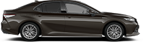 A hatchback and a sedan on a road